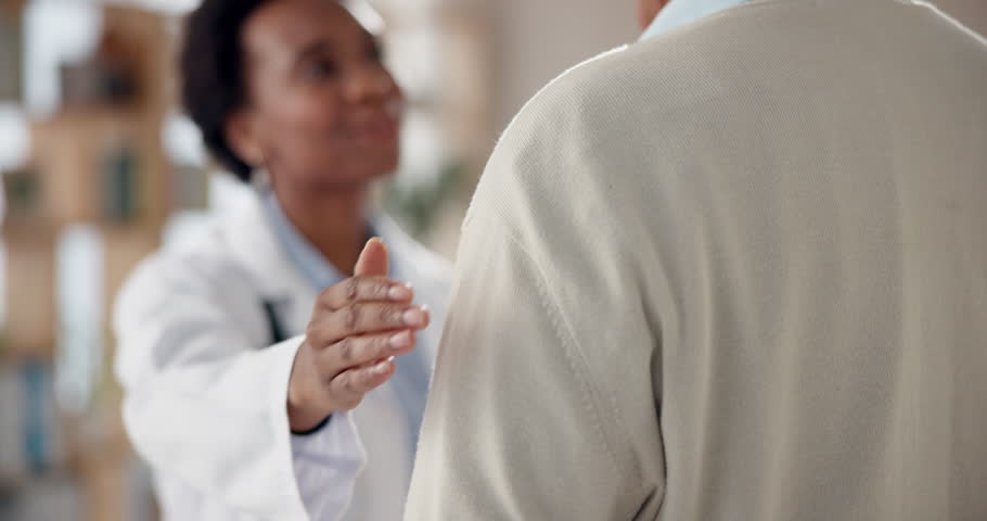 Doctor, hand on shoulder and senior man for advice in clinic for appointment, wellness and elderly care. Male patient, help and empathy as medic, staff and support in hospital for routine check up