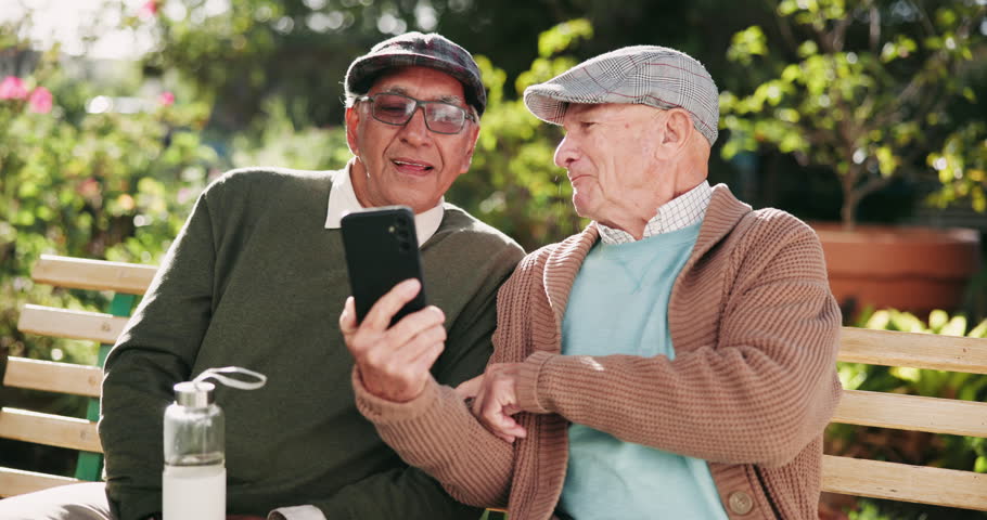 Bench, funny and senior men with smartphone, humor and relax with retirement, smile and connection. Outdoor, happy people and friends in park, cellphone and laughing for meme, joke and online comedy