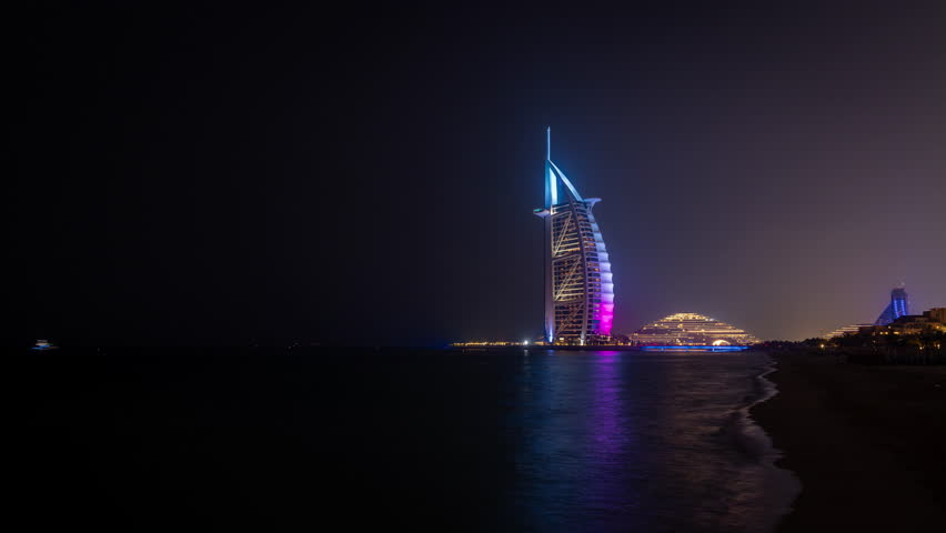 The famous Burj al Arab hotel in Dubai seen at night from the beach. A timelapse clip