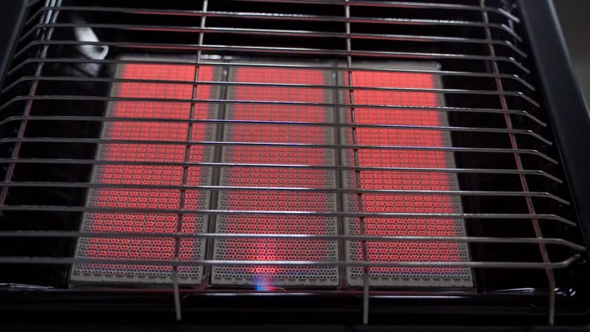 Switching heating and power modes on a portable gas heater, close-up. Heating of the room with a gas ceramic heater