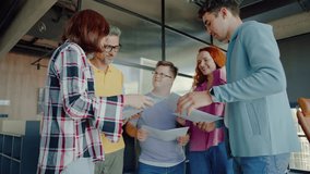 Selective focus on disabled person wearing eyeglasses while standing in circle of colleagues with happy smile. Team of diverse people of different ages and genders communicating during team building. - Powered by Shutterstock - Get 15% off with code: PIKWIZARD15