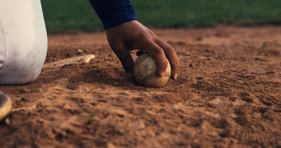 Super slow motion close up of baseball player taking from ground  baseball ball during competition game match on baseball stadium at 1000 fps.