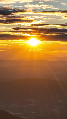 Sun goes down in summer evening at sunset in mountains nature Vertical Time lapse