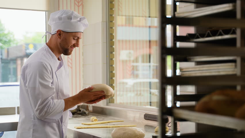 Baker chef is making with flour loaf of dough for preparation of pasta or pizza