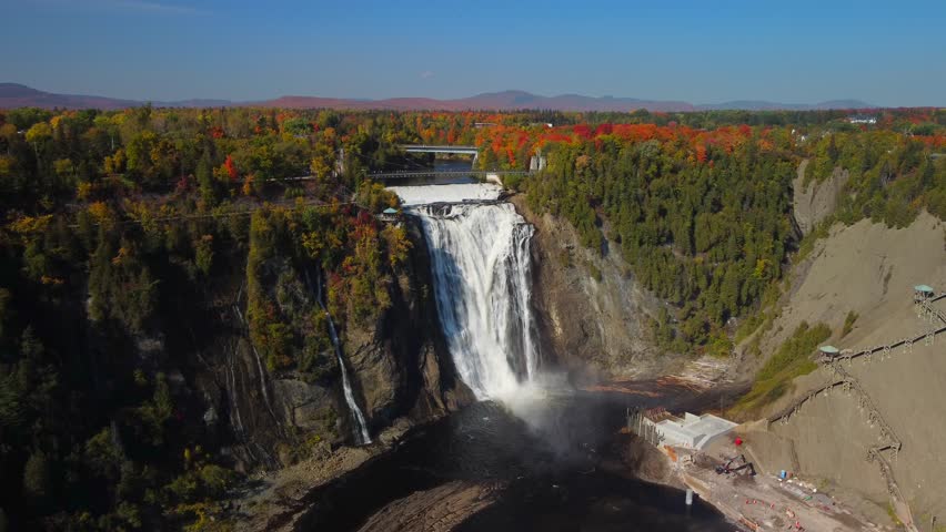 A drone landscape footage of Montmorency Falls with forest trees in Quebec, Canada