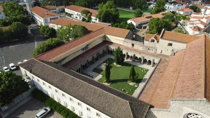 Aerial view of the historic Convent of São Francisco courtyard in Santarém, Portugal showcasing Gothic architecture and lush greenery.
