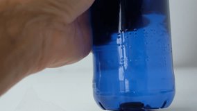 Braille font on a plastic water bottle. Raised dots on the plastic bottle. Person reads Braille. Read with fingers. Braille printing for plastic packaging. - Powered by Shutterstock - Get 15% off with code: PIKWIZARD15