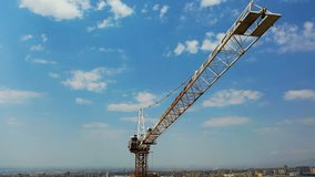 Crane tower in construction site. Industry construction concept footage. Drone view moving up around crane tower in construction site. Crane tower on city background.  - Powered by Shutterstock - Get 15% off with code: PIKWIZARD15