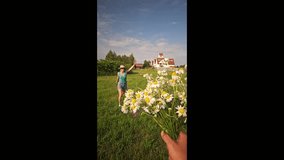 woman running across the field for a bouquet of daisies, field bouquet, happy girl, blue sky, clouds, old houses, woman in sherts, summer - Powered by Shutterstock - Get 15% off with code: PIKWIZARD15