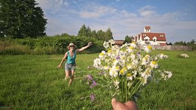 woman running across the field for a bouquet of daisies, field bouquet, happy girl, blue sky, clouds, old houses, woman in sherts, summer - Powered by Shutterstock - Get 15% off with code: PIKWIZARD15