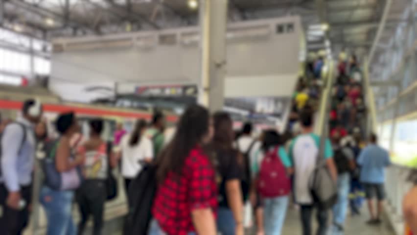 blurred image of people leaving the subway and going up the station stairs