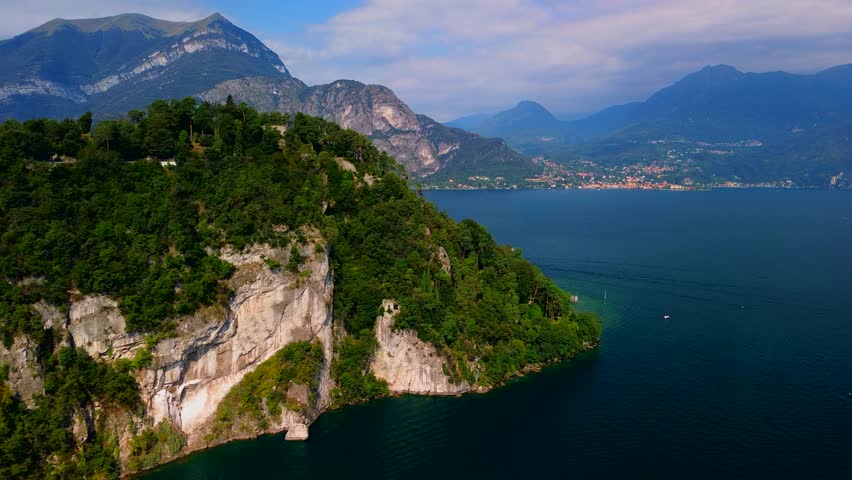 View from the air with beautiful views of the villas, alpine peaks and freshwater Lake Como. Green Planet. Luxury real estate of famous people. Nature. Flying a drone.