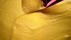 Gold paint smear of liquid paint texture background. Painting Golden metallic paint with a brush close-up. Liquid gold Art backdrop. Leaking Lipgloss, nail polish, make-up - Powered by Shutterstock - Get 15% off with code: PIKWIZARD15