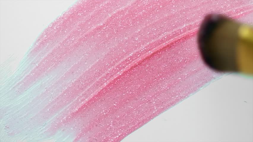 Lipgloss make-up smudge, smear. Cosmetic liquid lip gloss, lipstick pink color smudge, smear, stroke. Lip gloss Make up smears isolated on a white background. Brush. Smooth Texture 