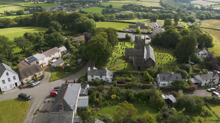 Aerial view of St Peter ad Vincula Church in Ashwater, showcasing the historic building and its picturesque churchyard in a rural setting, Devon, United Kingdom