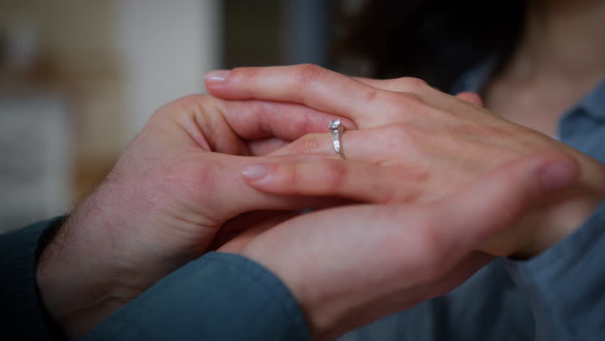 Couple engagement love affection feelings weeding celebration unrecognizable man guy male put ring jewelry diamond on female finger woman girl bride engage future family marry me propose marriage
