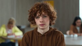 High school university teenager education study calm smiling peaceful serious Caucasian guy boy pupil teen male man schoolboy student studying learning college looking at camera class lesson portrait - Powered by Shutterstock - Get 15% off with code: PIKWIZARD15