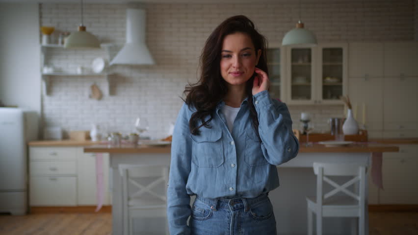 Happy loving Caucasian woman female girl wife girlfriend walk to sofa hugging embracing man busy computer addict laptop distant freelance working man male guy boyfriend husband couple talking home