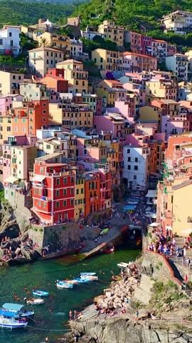vertical aerial video of Cinque terra in Italy, Riomaggiore town in Cinque terra on Italian riviera, vacation in Liguria, Italy, holiday in Italy. High quality 4k footage