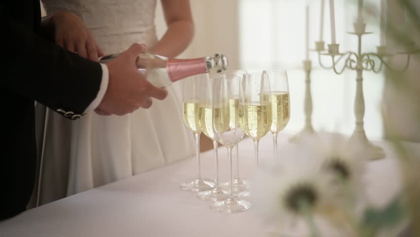 Bride and groom holding glasses of champagne at the wedding ceremony