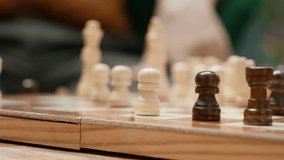 Happy senior people playing chess in a cozy home setting, thinking about strategy moves during board game leisure activity. Enjoyment of strategic intellectual hobby, mastermind pastime. Camera A. - Powered by Shutterstock - Get 15% off with code: PIKWIZARD15