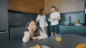 The morning routine of a family in a contemporary kitchen is a reflection of bonding during breakfast, highlighting modern domestic life filled with love and interaction - Powered by Shutterstock - Get 15% off with code: PIKWIZARD15
