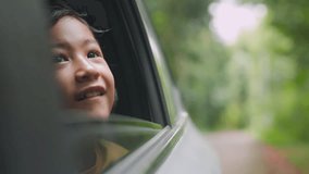 Road trip featuring adorable Asian girl looking out car window. Surrounded by lush greenery, it captures adventure, curiosity, and the innocence of childhood, highlighting travel and joyful moments. - Powered by Shutterstock - Get 15% off with code: PIKWIZARD15