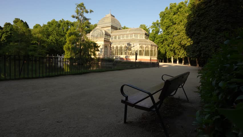 Retiro Park Madrid, Spain Sunrise. Park Bench Faces the Glass Palace in the Early Morning. No People.