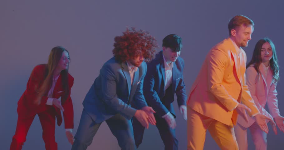 Dancers in bright neon lighting create exciting performance with dynamic and coordinated movements. Team dances in colorful costumes. Concept of advertising campaigns, dance shows and cultural events.