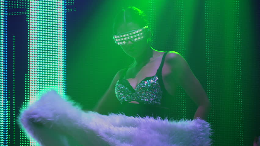 asian dancer in light fantasy costume dancing in night club with group of diversity happy woman sexy young people enjoy dancing 