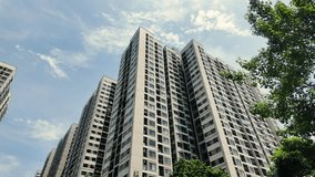 Dynamic low-angle view of residential high-rise buildings in motion. Camera panning upwards, showcasing the verticality of urban living. Balconies, windows, and architectural details passing by. Sense - Powered by Shutterstock - Get 15% off with code: PIKWIZARD15