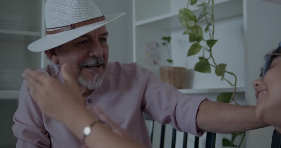 MULTIETHNIC FAMILY
Hispanic Latino family enjoying a happy moment, eating and sharing with good humor and happiness. Grandfather having a good time with his granddaughter, showing affection and love. 