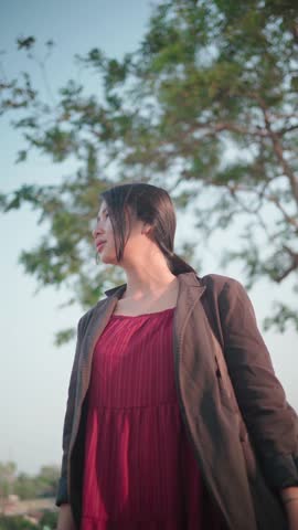 Asian women wearing red dresses outdoors