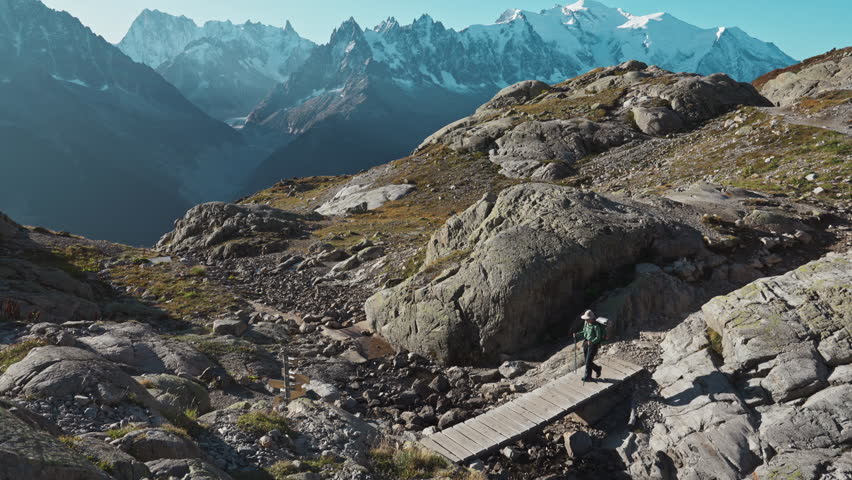 Active hiker woman hiking on Lac Blanc with Mont Blanc massif among French Alps at Haute Savoie, France