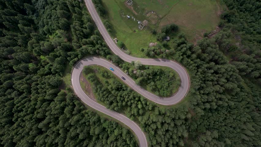 Curve asphalt road on mountain forest summer.	
Aerial view of the road passing through the mountain and green forest. 