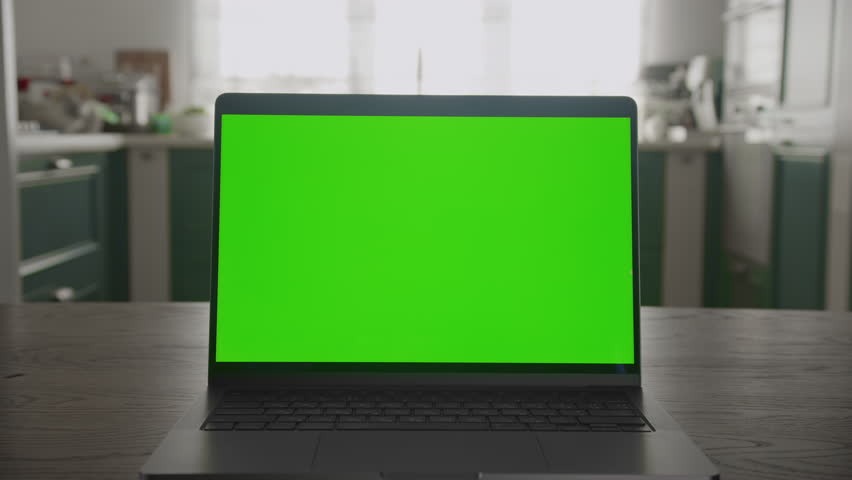 Laptop with Green Screen on Kitchen Table Zoom Out