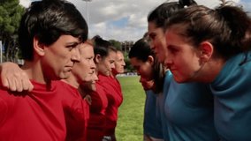Female rugby players in red and blue jerseys face off in a close-up, showing focus and determination before a match. Intense Face-Off Between Female Rugby Teams - Powered by Shutterstock - Get 15% off with code: PIKWIZARD15