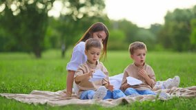 Family Picnic Pregnant Mom and Twins Paper Airplanes White. Happy pregnant mom smiles and walks in the park with twins.Happy family enjoying summer holidays.
Happy Mom and twins smiling. - Powered by Shutterstock - Get 15% off with code: PIKWIZARD15