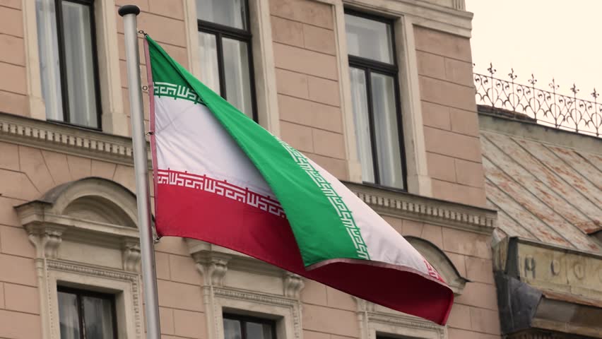 The Iran national flag waving. The Islamic Republic of Iran is a State of Asia located on the Middle East. Slow motion 