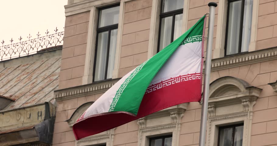 The Iran national flag waving. The Islamic Republic of Iran is a State of Asia located on the Middle East. Slow motion 