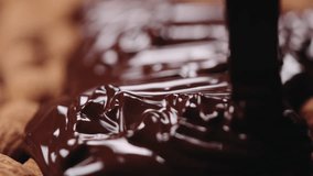 Slow motion closeup covering roasted almonds with melted dark chocolate - Powered by Shutterstock - Get 15% off with code: PIKWIZARD15