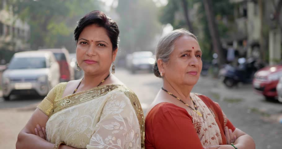 Sardar nagar, Sion, Mumbai, India- December 27th 2023-Close high speed shot of two Indian females smiling towards.