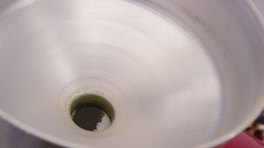 Coffee beans are poured into the roasting machine. Raw yellow or green caffeine seeds are poured into the roaster. Production of french fries cocoa