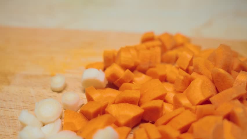 Chopped carrot vegetables in kitchen, cutting board. Closeup macro shot. White carrot.
