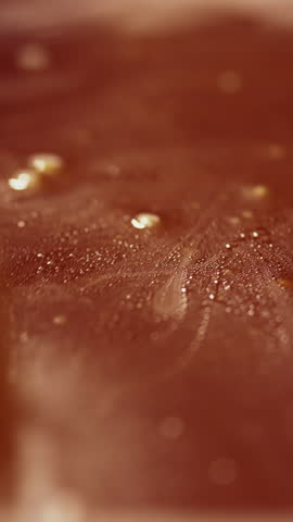 Caramel is stirred with a spoon during cooking. Slow motion