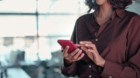 Closeup of impersonal woman's hands using cell phone mobile AI app for work call, business communication, trading. Busy female woman businesswoman working on smartphone, texting, walking in office - Powered by Shutterstock - Get 15% off with code: PIKWIZARD15