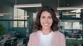 Headshot face portrait of beautiful successful hispanic young business woman smiling confident at camera. Latin, indian or middle eastern female ceo leader businesswoman standing proudly in office. - Powered by Shutterstock - Get 15% off with code: PIKWIZARD15