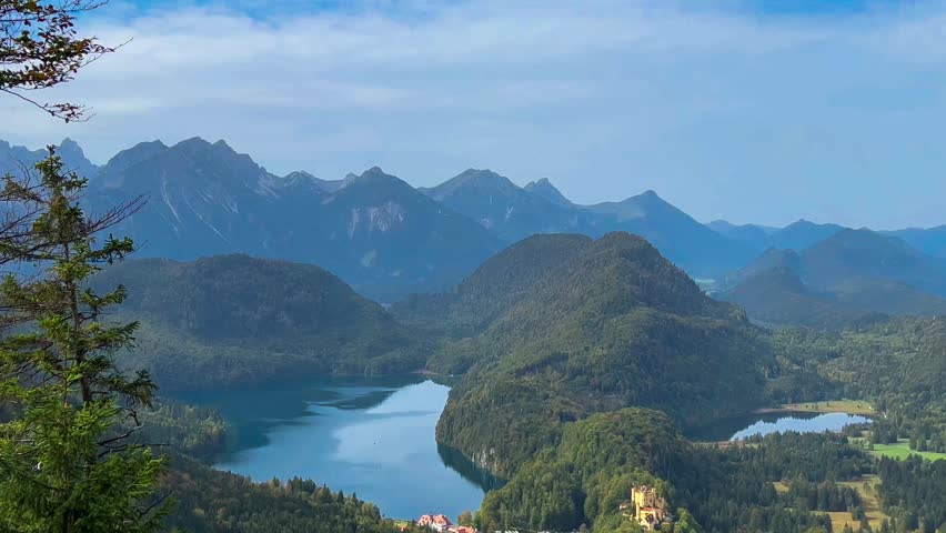 Landscape lake in mountains among pine forest in vicinity of the castle Neuschwanstein castle on Alps background, Bavaria, Germany, Europe. Autumn landscape lake in mountains 