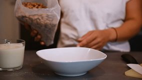 Woman Pours Cereal Into a Bowl For Breakfast - Powered by Shutterstock - Get 15% off with code: PIKWIZARD15