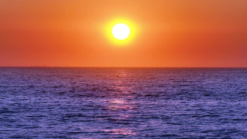 A landscape scene of fray sea dunes under sun disk at sunset, for wallpaper
